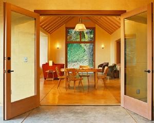 The large, open living and dining space is shown in this photograph. - Photo Credit: JD Peterson