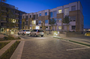This photograph shows a night view of Synergy townhouses at Dockside Green. - Photo Credit: Enrico Dagostini
