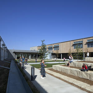 The school's courtyard is a hub of activity for student of all ages, as depicted in the photo. - Photo Credit: (c) Farshid Assassi