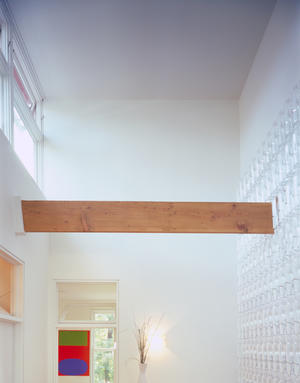 The south-facing clerestory window shown here brings light to the core of the house, reducing the need for artificial lighting. This light warms the water bottles to help heat the house in the winter. - Photo Credit: Doug Snower Photography