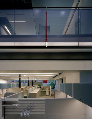 A line of continuous operable windows at the bottom and top of all of the north and south double-height glazed curtainwalls opens to provide stack effect ventilation, cross ventilation, and cooling, with cool air being drawn up from the landscape ground cover. The glazed curtainwalls, visible in this photo, allow deep penetration of sunlight into the building’s floor plate. - Photo Credit: Mariusz Mizera