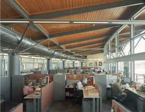 This photo shows the low-walled work spaces and demonstrates how the narrow floor plate enables daylight to penetrate to the center of the floor. - Photo Credit: Timothy Hursley