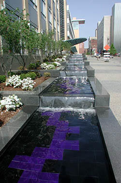 This photo shows the system of recirculating waterfalls, cascades, and streams that reduces the sidewalk temperature around the building. - Photo Credit: Massery Photography, Inc.--L.D. Astorino Companies