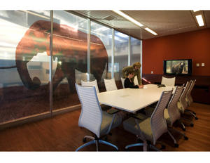 The client's mission—protecting wildlife-is reflected at all scales of the building. Shown in this photograph is one of the translucent images of various wildlife and habitats visible on expansive glass partitions in the collaboration rooms. - Photo Credit: © Peter Vanderwarker 2008