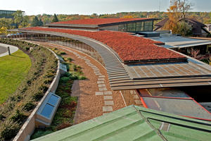 This photo views the new addition from the roof of the older B-Wing; the vegetative roof, drought-tolerant native landscaping, and rain gardens can be seen. - Photo Credit: The Kubala Washatko Architects, Inc. / Zane Williams