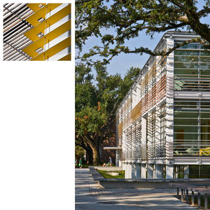 The sloped light wells at the base of the building, shown in this photo, allow daylight into the building and help with stormwater management. - Photo Credit: Paul Crosby