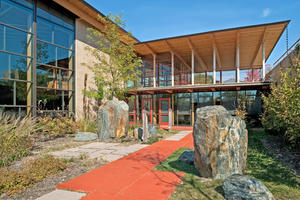 The East Courtyard pictured in the photo helps absorb stormwater runoff and provides outdoor views from the atrium auditorium, music room, and main entrance. - Photo Credit: The Kubala Washatko Architects, Inc. / Zane Williams