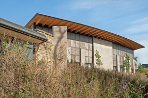 Southern exposure allows filtered natural daylight in the atrium auditorium, as shown in the photo. - Photo Credit: The Kubala Washatko Architects, Inc. / Zane Williams