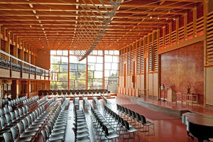 This photo show the new 500-seat atrium auditorium, featuring abundant natural daylight and ventilation. A sunscreen reduces glare from early morning sunlight. - Photo Credit: The Kubala Washatko Architects, Inc. / Zane Williams