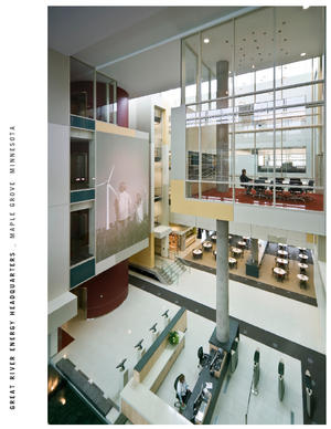 This photograph highlights the building's light-filled main entry atrium and the elevated Willow Conference Room, which is supported by a single cast-in-place concrete column. Great River Energy produces some the highest quality flyash pozzolana in the country. The conference room demonstrates the use of their product. - Photo Credit: Don F. Wong