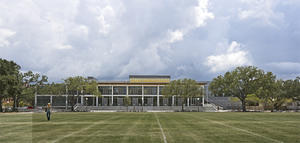 This photo shows the building in its context between green spaces on campus. - Photo Credit: Paul Crosby