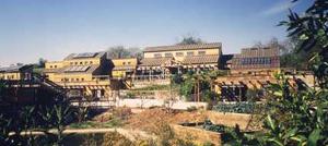 This overview photo of Phases I and II illustrates student agricultural projects and the aquaculture pond. - Photo Credit: Milroy & McAleer