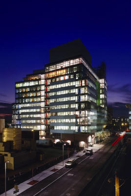 This photo was taken at night, from the northeast. Light pollution is controlled by reflective lighting, controlling indoor lights, and shading with an automated blind system after dark. - Photo Credit: Roland Halbe