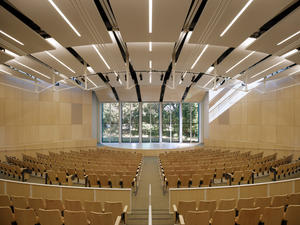 This photograph shows the auditorium and its view to native oak grove, a natural backdrop to lectures, presentations and liturgical services. - Photo Credit: Tim Griffith