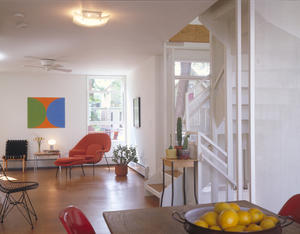 The plan layout uses a 2'-0" wood framing module to minimize material waste. The careful placement of windows, including those shown in this photograph, maximizes reflected light into the home and reduces glare. The flooring on the first floor, visible in this photo, consists of cork tiles, a long-lasting and renewable product. - Photo Credit: Doug Snower Photography