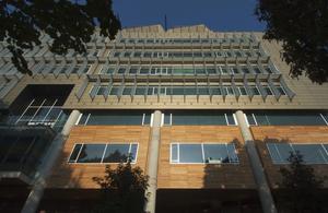 This photo shows the building's east facade, with sun shading and lightshelves. - Photo Credit: Hester + Hardaway