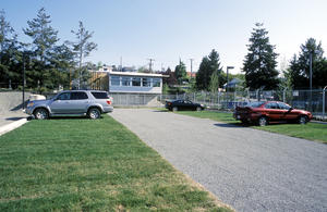 Landscape design included dramatic increases in open space around the building through the reduction of paved area on the site. 4,050 ft2 of paving was returned to nature. As shown in this photo, 4,758 ft2 of parking surface was replaced with grass/gravel pave. - Photo Credit: Colin Jewall