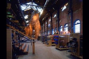 REI's signature climbing pinnacle is visible beyond the retail merchandise in this photograph. - Photo Credit: Robert Pisano