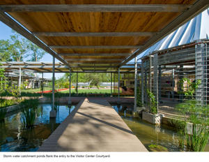 This photograph shows storm water catchment ponds that flank the entry to the Visitor Center Courtyard. - Photo Credit: Hester + Hardaway Photography