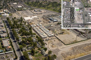 This aerial image shows the project's urban context. Significant adjacencies include mixed-income housing to the west, a public park to the northeast, a fire training center directly south, and mixed industrial buildings. - Photo Credit: Tate Snyder Kimsey Architects