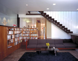 Principal living space with remodeled kitchen dining area in background showing abundant daylight and view through house - Photo Credit: Marvin Rand
