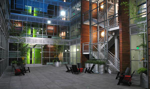 This dusk shot of the exterior courtyard looking at the building entry highlights the transparent qualities of the exterior glass and steel façade. - Photo Credit: Gabe Hanson