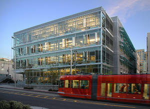 This is a photograph from Thomas Street at dusk showing the sleek new South Lake Union streetcar and the expressive elevations of the Terry Thomas building. - Photo Credit: Gabe Hanson