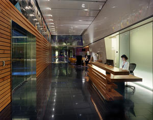 The walls of the apartment lobby utilize reclaimed fir from a former trolley barn. The wood warms the entry and was also used to construct the concierge desk. - Photo Credit: Eckert & Eckert