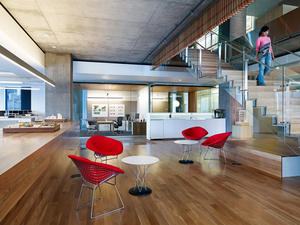 Each office floor features alternating interior communicating stairs. The space around each stair landing is meant to serve as a community lounge area with a kitchenette and seating space to foster employee interaction. - Photo Credit: Basil Childers