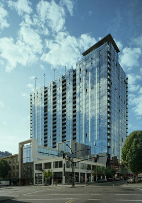The carefully articulated curtain wall gives the building a thin and planar structural aesthetic. Subtle textural modifications include operable windows, balconies, quilted and recessed stainless steel of varying color, and fritted reflective semi-opaque panels which create a lively enclosure with a sense of movement. - Photo Credit: Tim Hursley