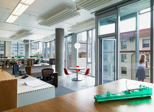 The office floors comprise an open floor concept. Natural daylight views, operable windows, balconies, underfloor air, chilled beams, radiant heating and cooling, CO2 monitoring and low-emitting materials combine to make a healthy work environment. - Photo Credit: Basil Childers