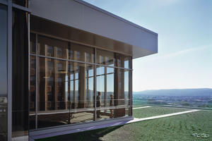 In this photograph, a daylit atrium overlooks the lower vegetated roof. - Photo Credit: Peter Aaron - Esto