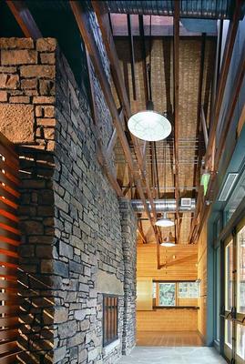 The fireplace at the entry of the multipurpose room is shown here. - Photo Credit: Nic Lehoux