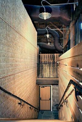 The stair shown here leads from the upper barn to the main interior space. - Photo Credit: Nic Lehoux