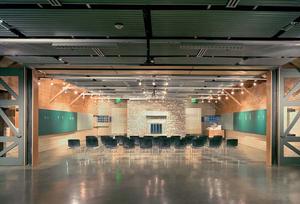 This photo shows the multipurpose room with the moving wall in its upper position. - Photo Credit: Nic Lehoux