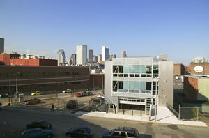 This photograph of the main entry shows the project's urban industrial context. - Photo Credit: Richard Mandelkorn
