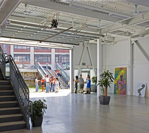 The gallery is shown in this photograph with the overhead door fully open to the sunken courtyard. - Photo Credit: Richard Mandelkorn