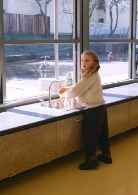 This photo shows a child using the art sink area. - Photo Credit: Richard Parker