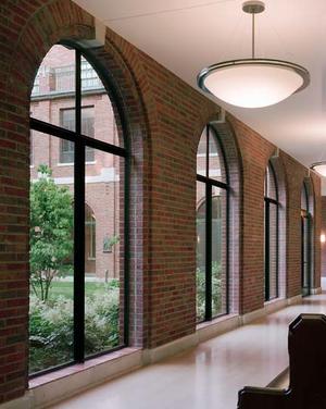 This photo of the renovated cloister shows the dramatic increase in daylight and views resulting from restoring this space. - Photo Credit: Barry Halkin Photography