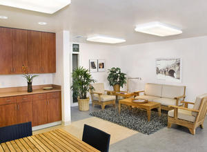 The community room uses sustainably grown wood products and recycled furniture and carpet tiles, as shown in this photo. - Photo Credit: Bernard Andre Photography