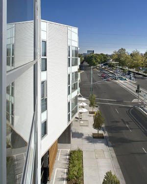 This photograph was taken from a balcony that offers daylight, views and natural ventilation, while noise is reduced by the use of glass railings. - Photo Credit: Bernard Andre Photography
