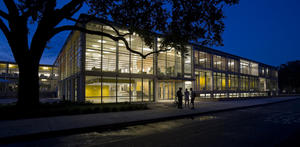 This photo shows the southeast facade at night, with the sunshades visible. - Photo Credit: Paul Crosby