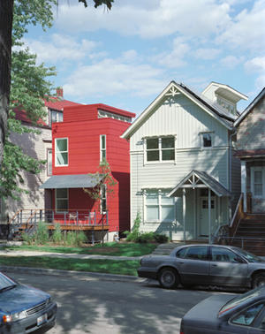 A basement was designed for future expansion and to facilitate a raised porch and stairs, a common layout in the neighborhood. The porch, visible in this photo, includes corrugated metal awnings that help channel air through the windows, provide cover, and minimize heat gain. - Photo Credit: Doug Snower Photography
