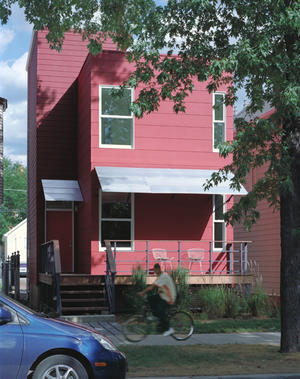 Factor 10 House's modular design minimizes waste of materials and allows for off-site assembly. The siding, visible in this photo, is made of reconstituted cement and colored with a low-emission stain. The wrap-around deck is constructed from certified Ipe, a Brazilian hardwood that naturally resists rot, decay, insects, and mold. This strong, dense wood, whose expected lifespan is more than 25 years, is naturally fire resistant and harvested from naturally sustainable forests. - Photo Credit: Doug Snower Photography