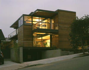 The Z6 House, viewed in this photo from the street, was built into a slope that resulted from paving over sand dunes when the neighborhood was first built. - Photo Credit: Grant Mudford