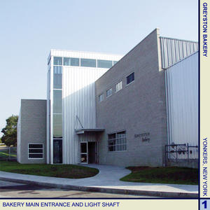 This photo highlights the bakery's main entrance and the light shaft. - Photo Credit: Cybul and Cybul Architects