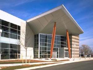 The entrance, shown in this photo, is defined by steel beams painted Herman Miller Red that declare "enter here!" - Photo Credit: Hedrich Blessing